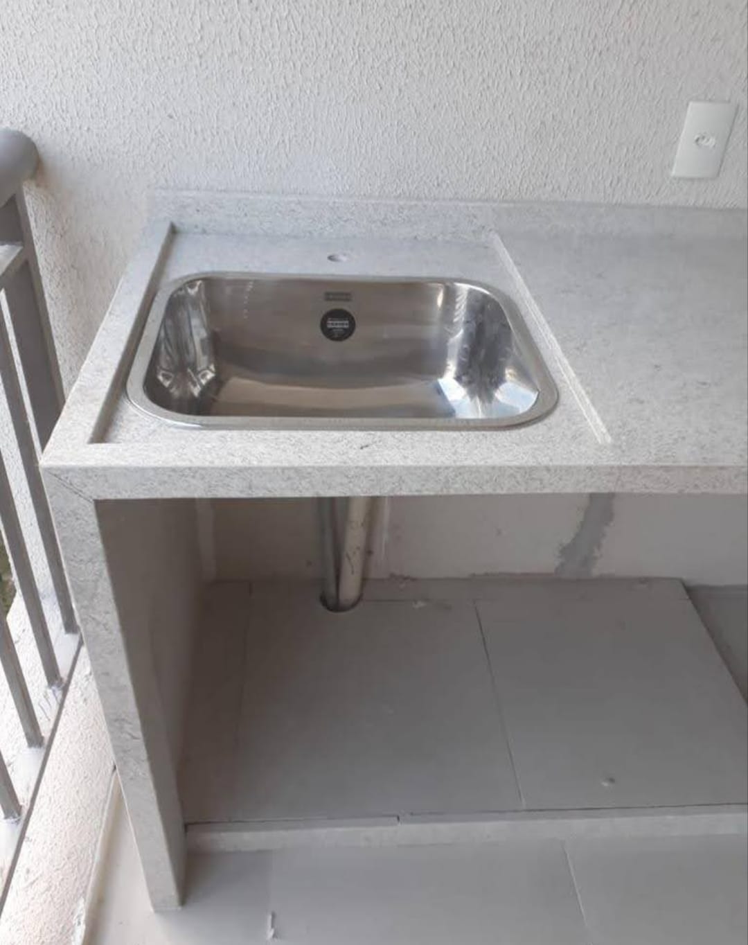 Bancada de área externa em granito cinza com tanque de inox embutido